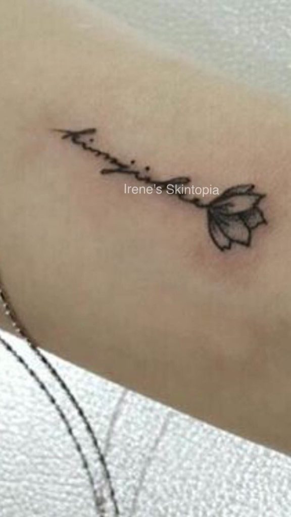 A tattoo of a flower with the word 