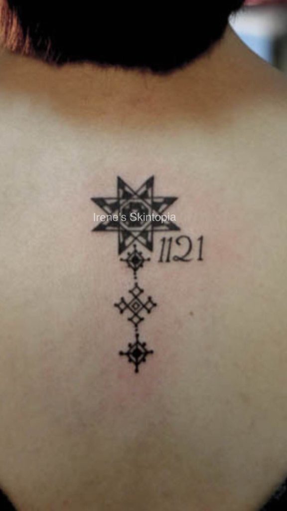 A tattoo of a star and the number 1 1 2 1.