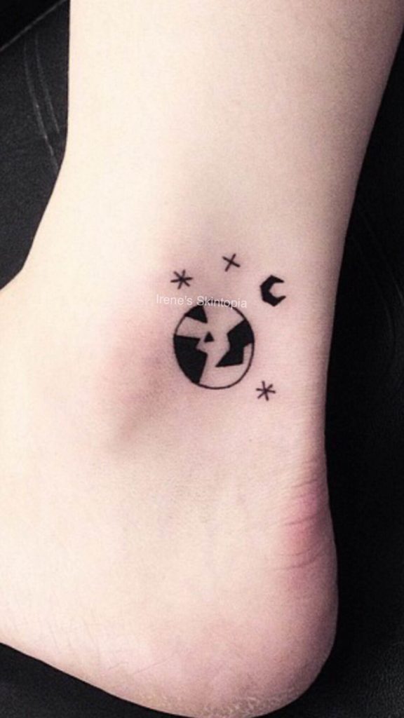A small tattoo of the earth and stars.