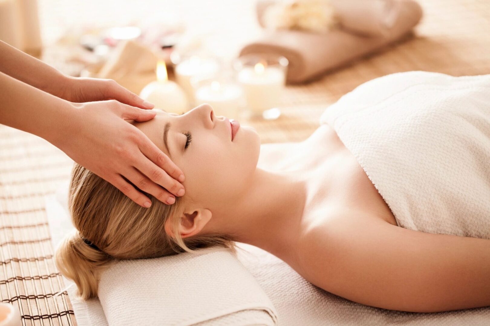 A woman getting her head washed by a masseuse.