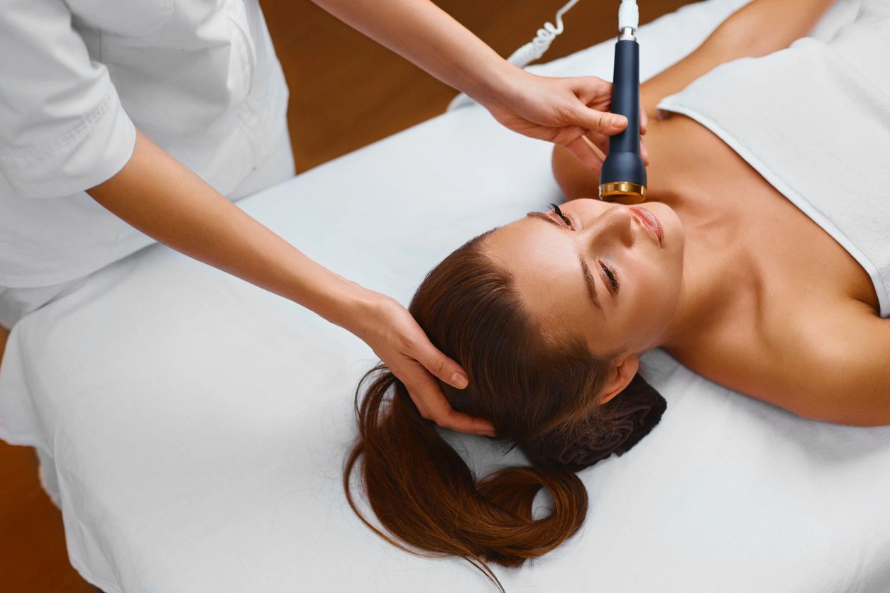 A woman getting her face waxed at the spa